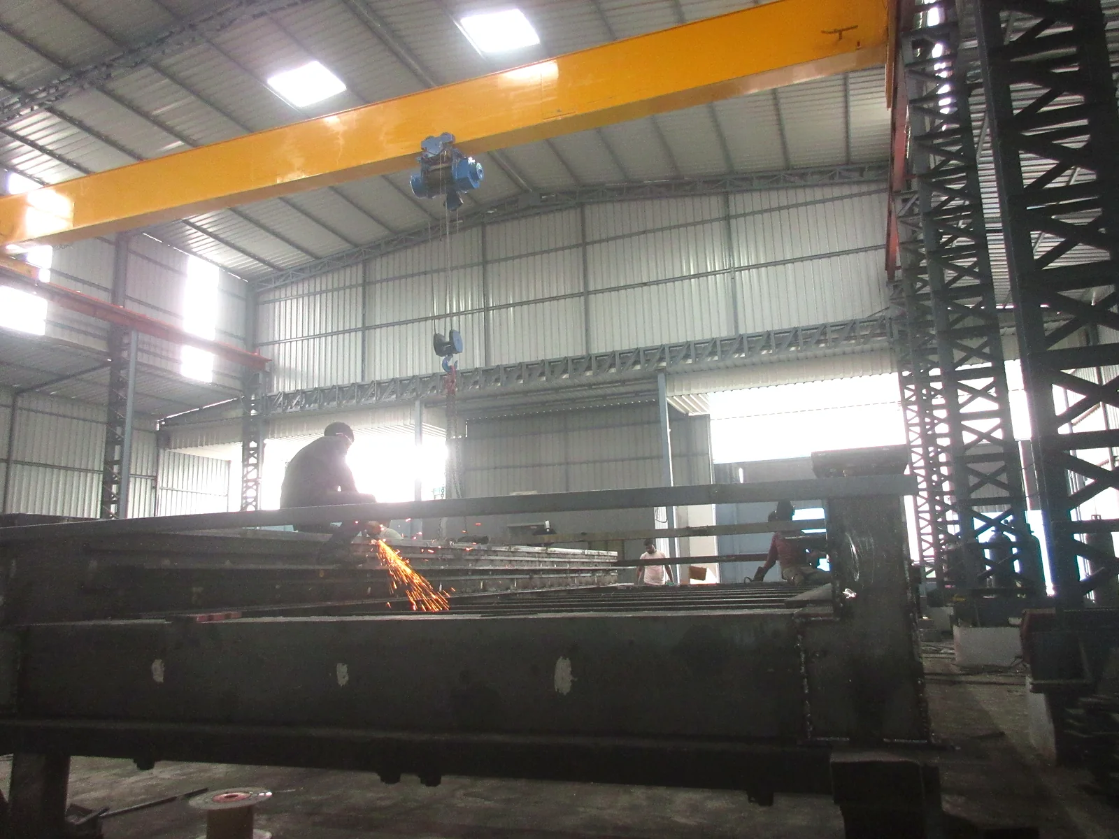 Structural steel fabrication work inside the Naxos Chakan facility
