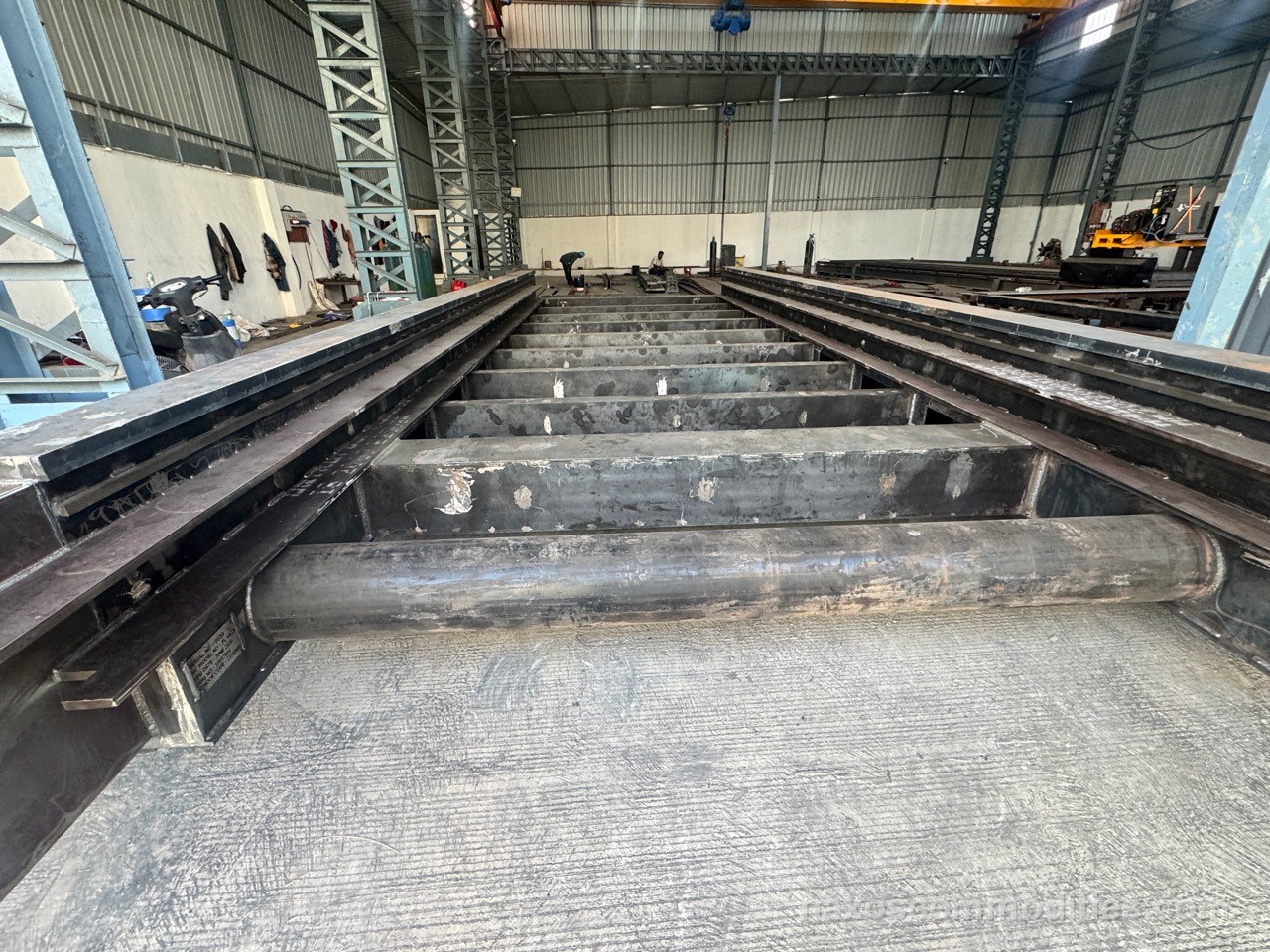 Large laser machine base frame under fabrication with ribbed welded steel members